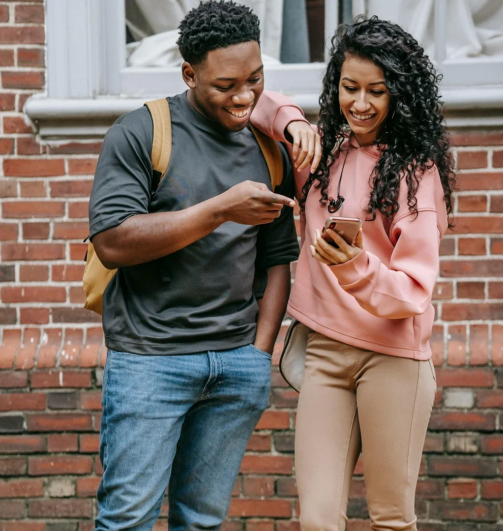 Two people looking at a phone