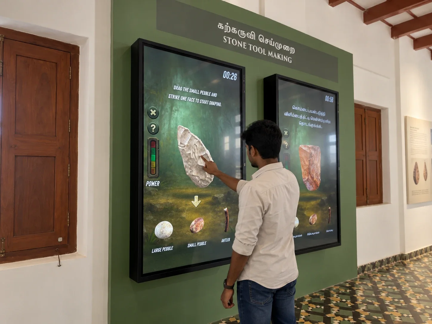 A visitor shaping a stone tool on screen