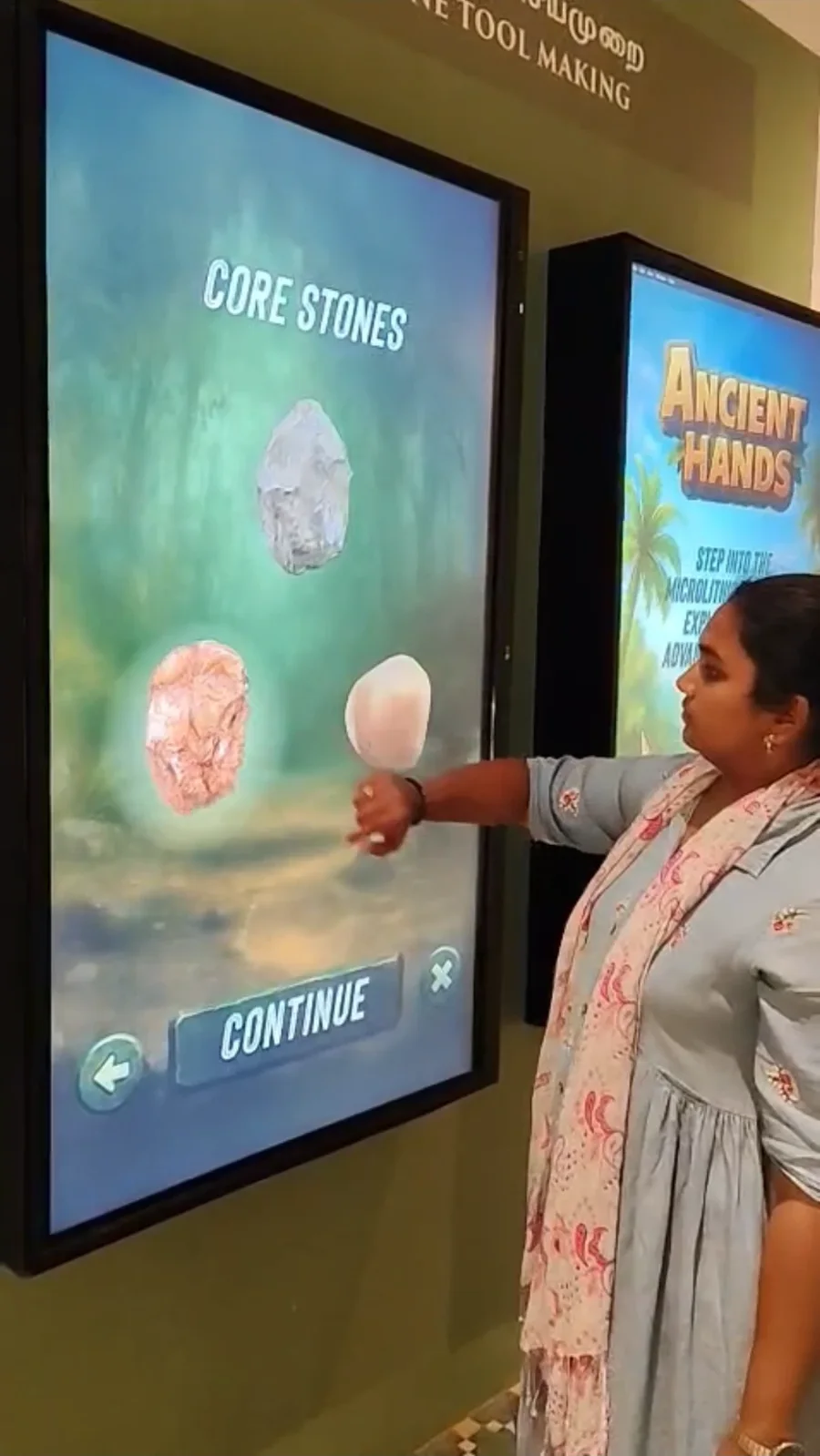 A visitor choosing a core stone