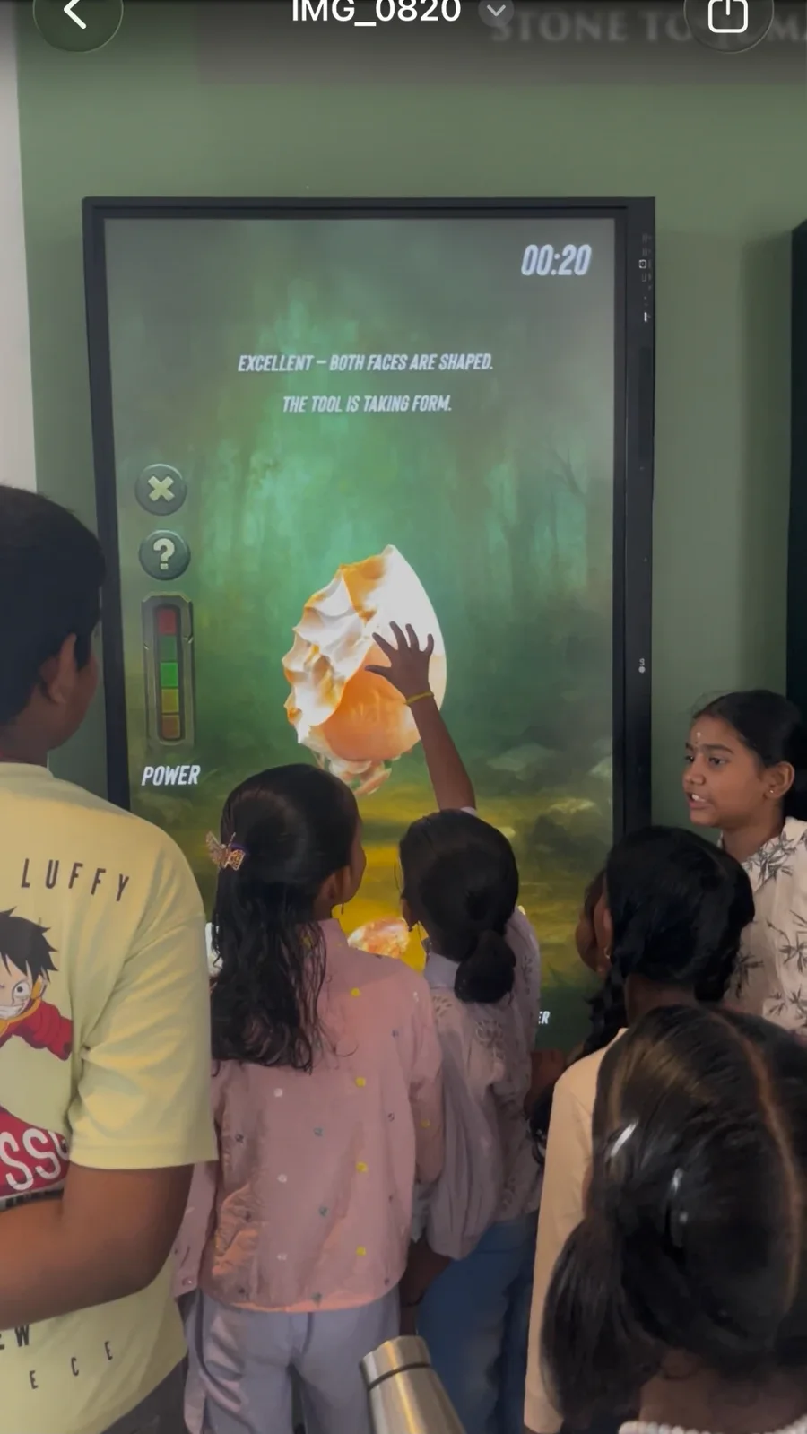 Children shaping a stone tool