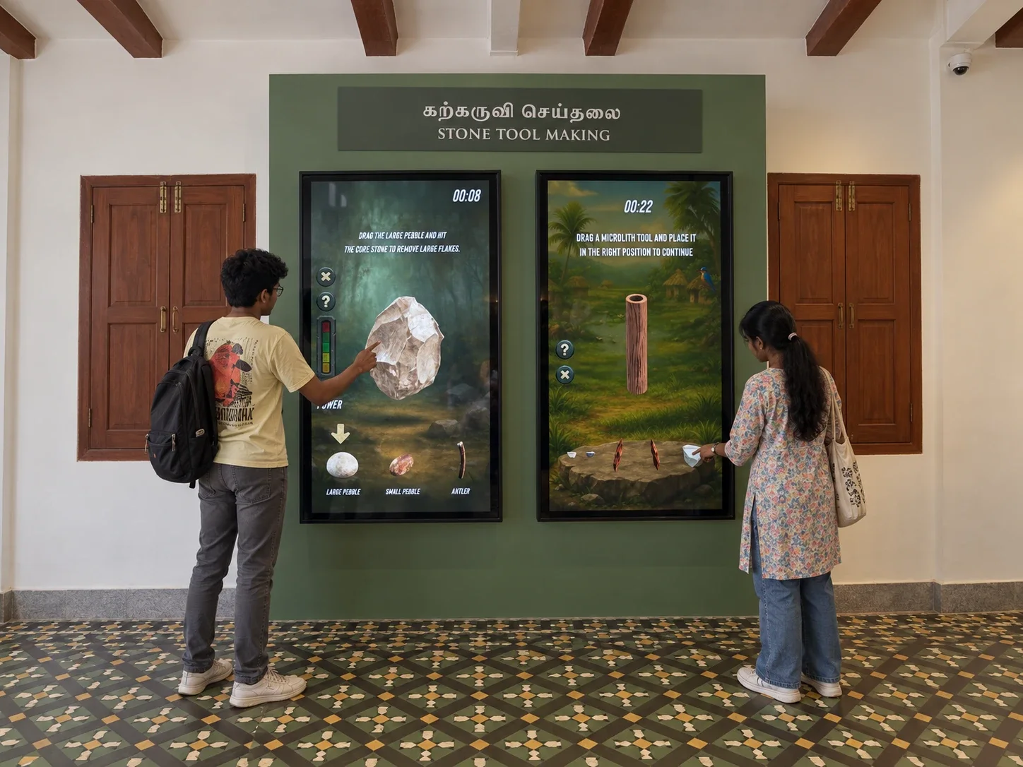 Two visitors playing Ancient Hands at the Stone Tool Making wall